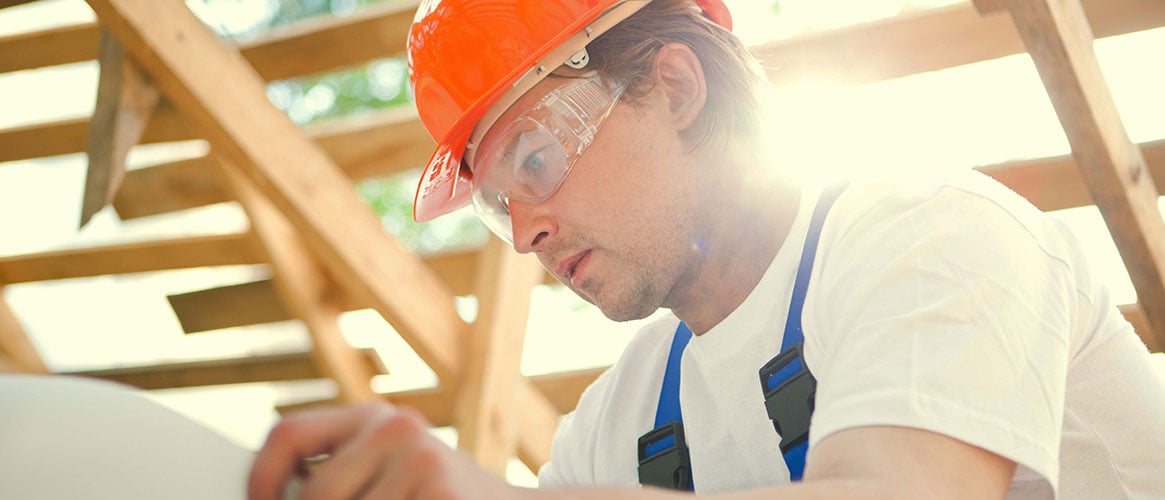 Fair-skinned construction worker protected from ultraviolet radiation by protective clothing and sunblock