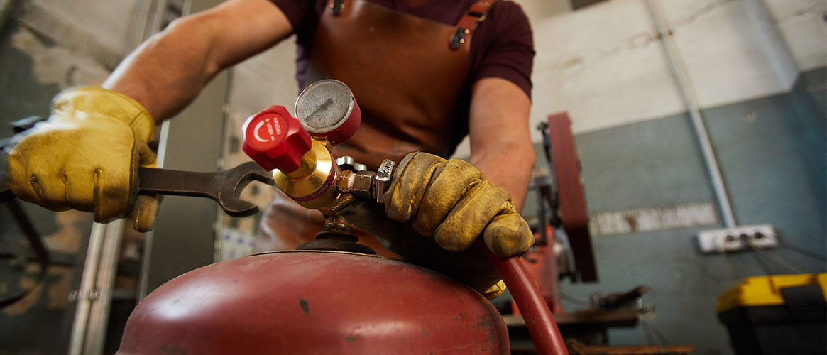 Worker using a wrench to close the valve