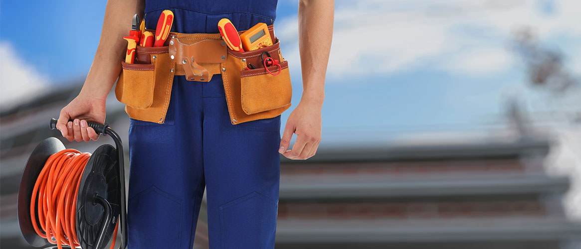 Construction worker holding a coiled up extension cord