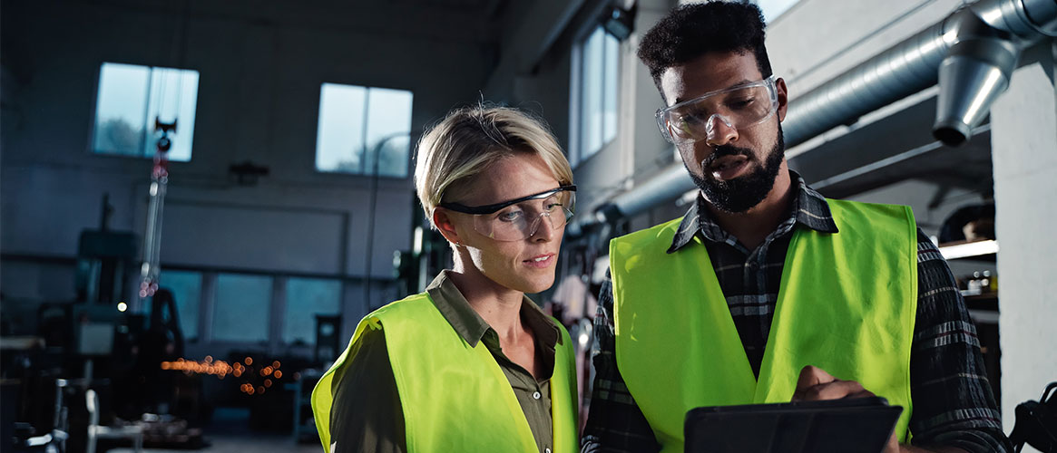 Coworkers discussing safety while at work Coworkers discussing safety while at work